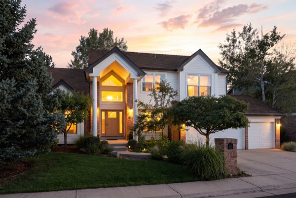 A Golden, Colorado home glowing at twilight beneath the foothills